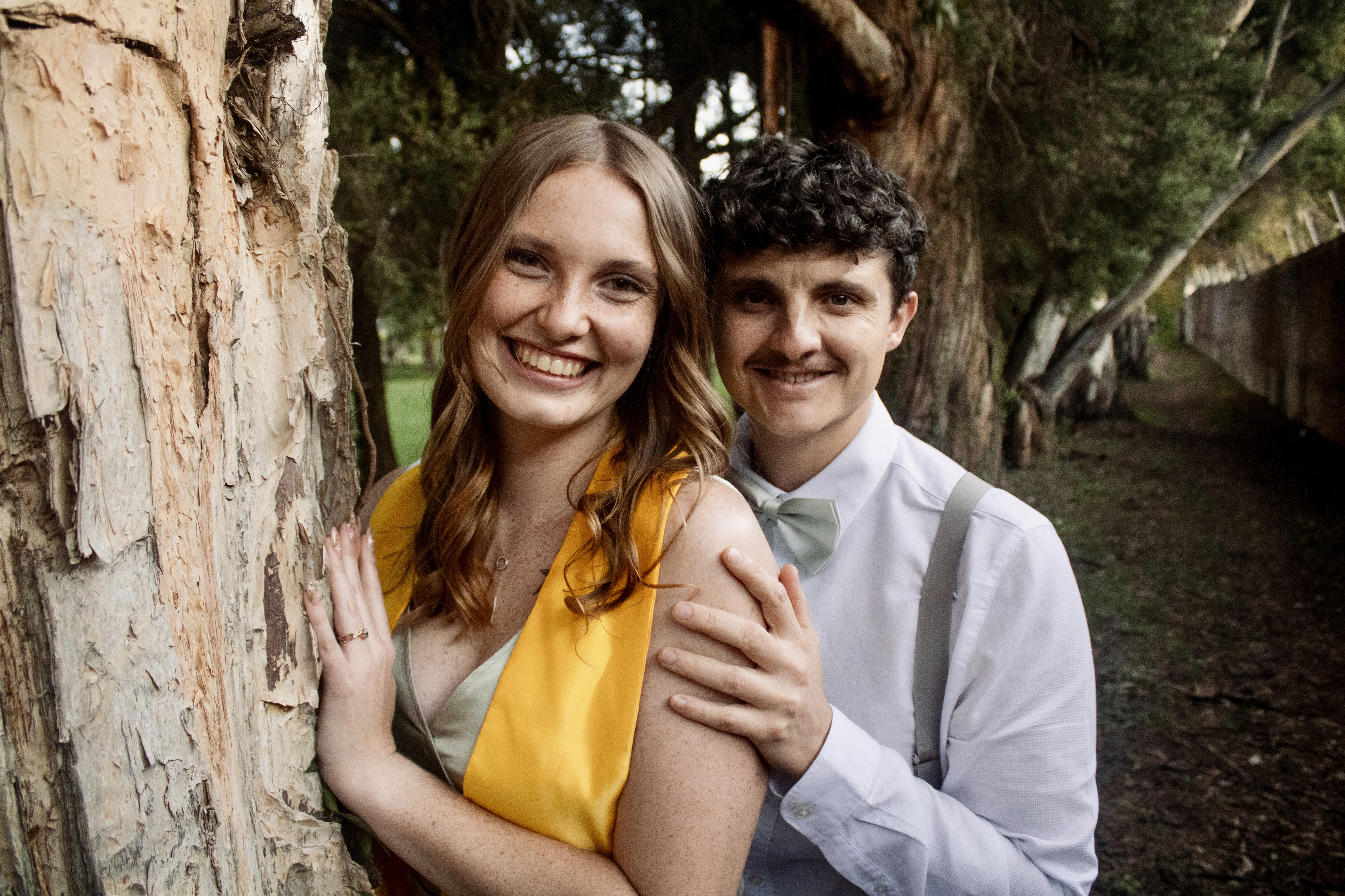 Hannah and Mitchell by a tree